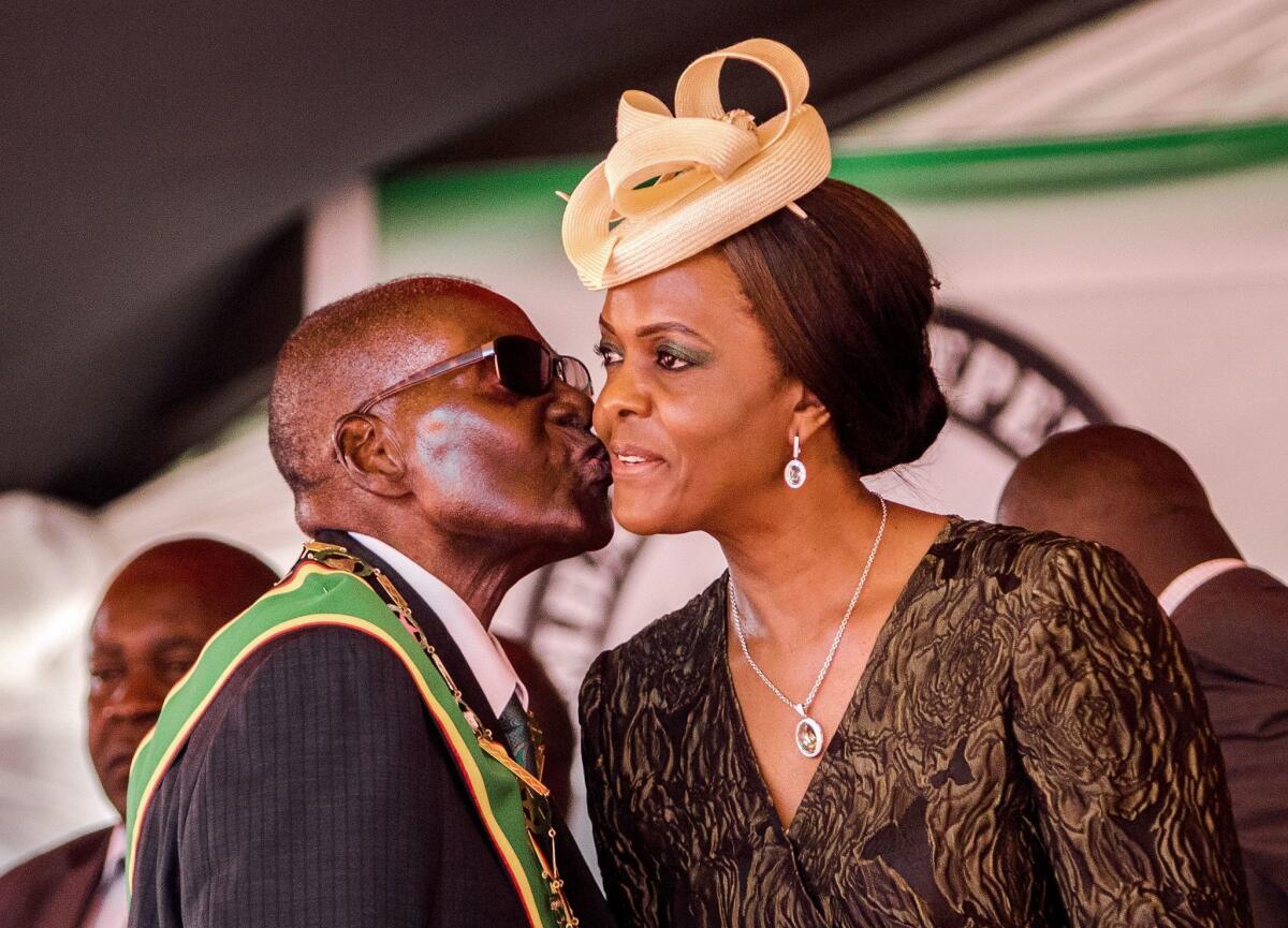 President Robert Mugabe kisses his wife, Grace Mugabe, during the country's 37th Independence Day celebrations on April 18, 2017.
