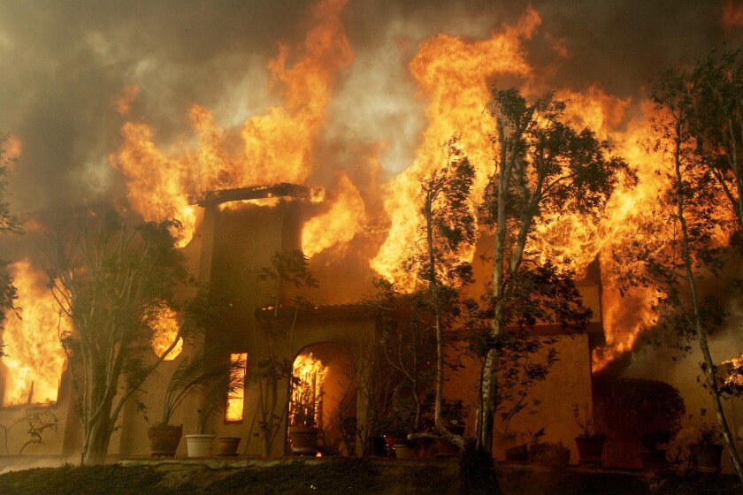 A house on fire near Lake Hodges in October 2007.