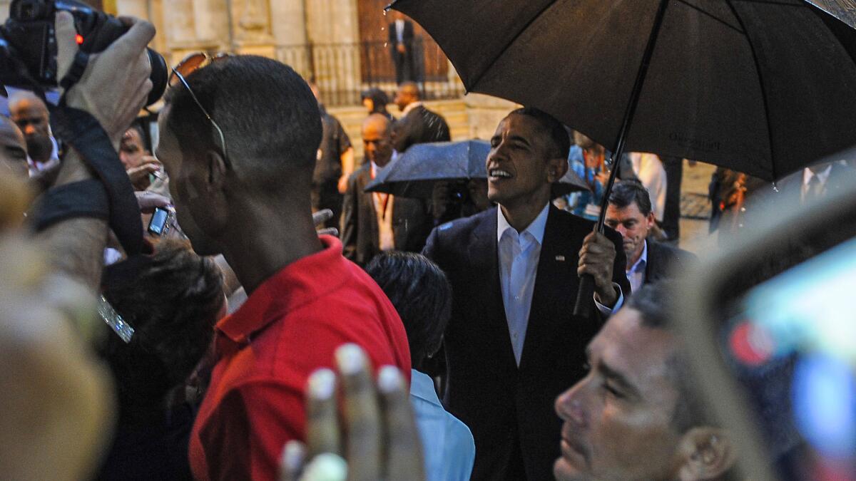 President Obama talks to tourists and Cubans on his arrival at the Havana Cathedral on Sunday.