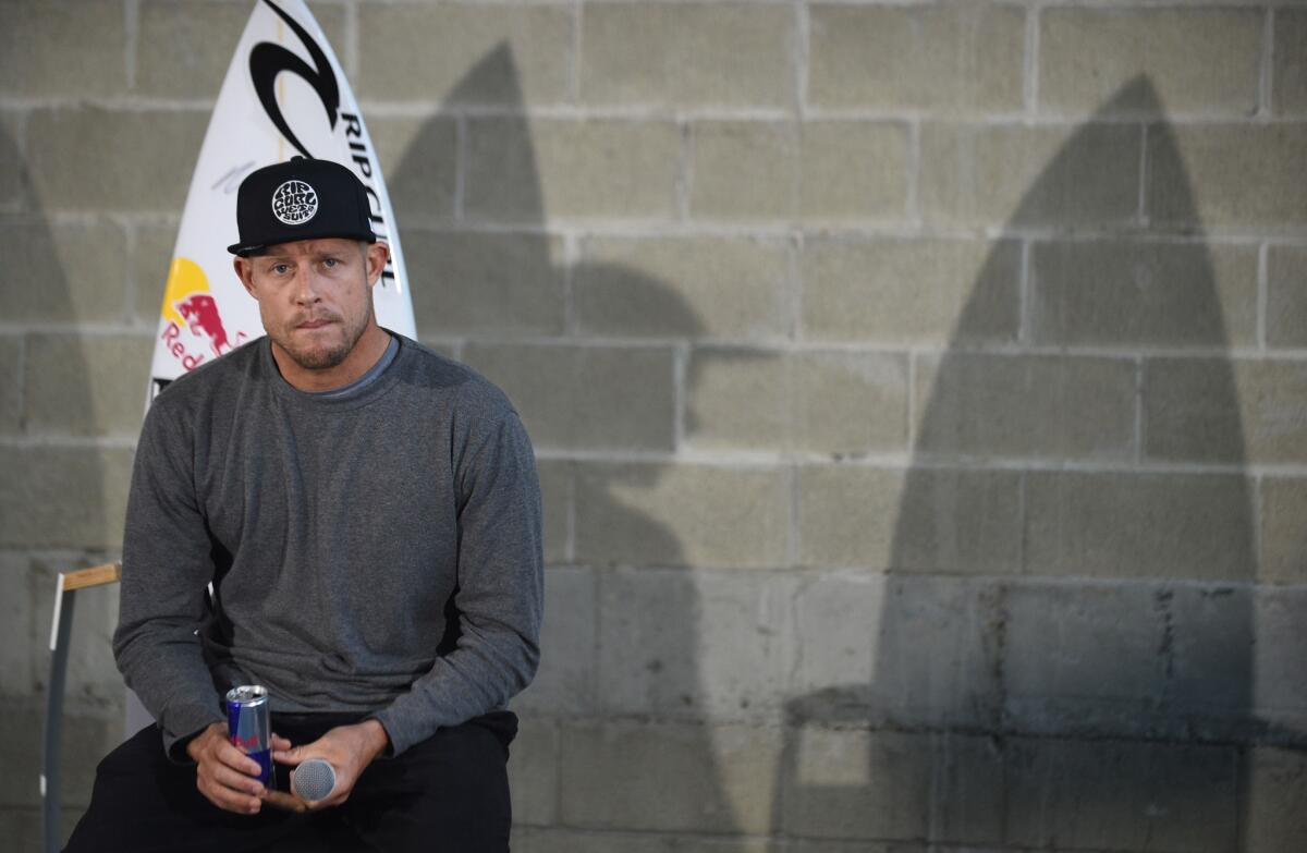 Australian surf champion Mick Fanning listens to a question at a press conference in Sydney after he flew in from South Africa, where he fought off a shark during a surf event.