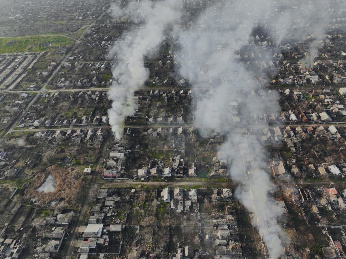 An aerial photo shows smoke billowing from buildings after Russian attacks.