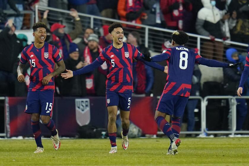 United States' Antonee Robinson (5) celebrates his goal with Weston McKennie (8) and Chris Richards (15) during the second half of a FIFA World Cup qualifying soccer match against El Salvador, Thursday, Jan. 27, 2022, in Columbus, Ohio. (AP Photo/Julio Cortez)