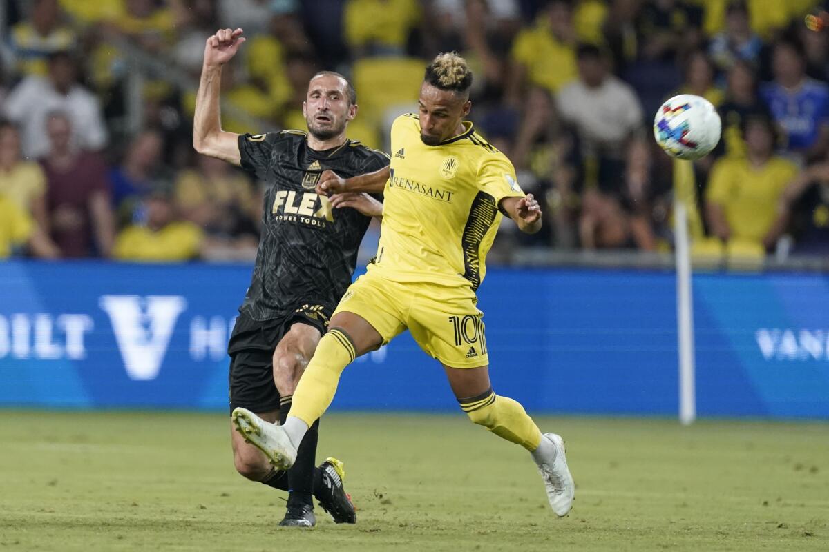 LAFC's Giorgio Chiellini, left, and Nashville's Hany Mukhtar chase the ball.