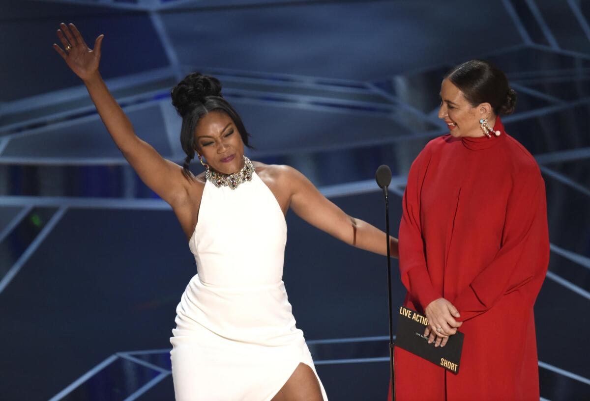 Tiffany Haddish, left, and Maya Rudolph onstage at the Oscars.