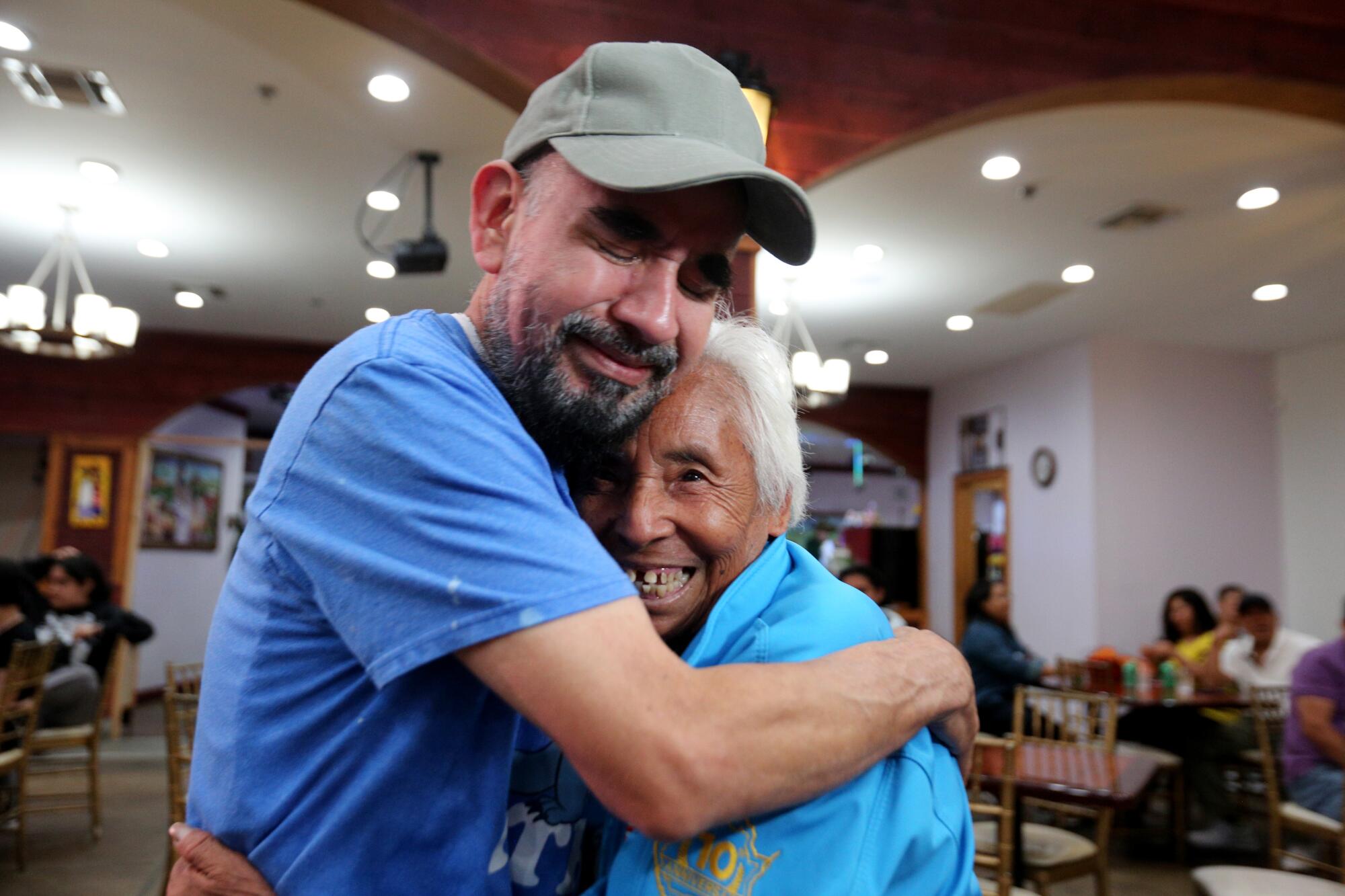 After 34 years of not seeing her, Alberto Martinez, 53, of L.A., hugs his mother Irene Hernandez Mejia, 81 of Morelos, Mexico