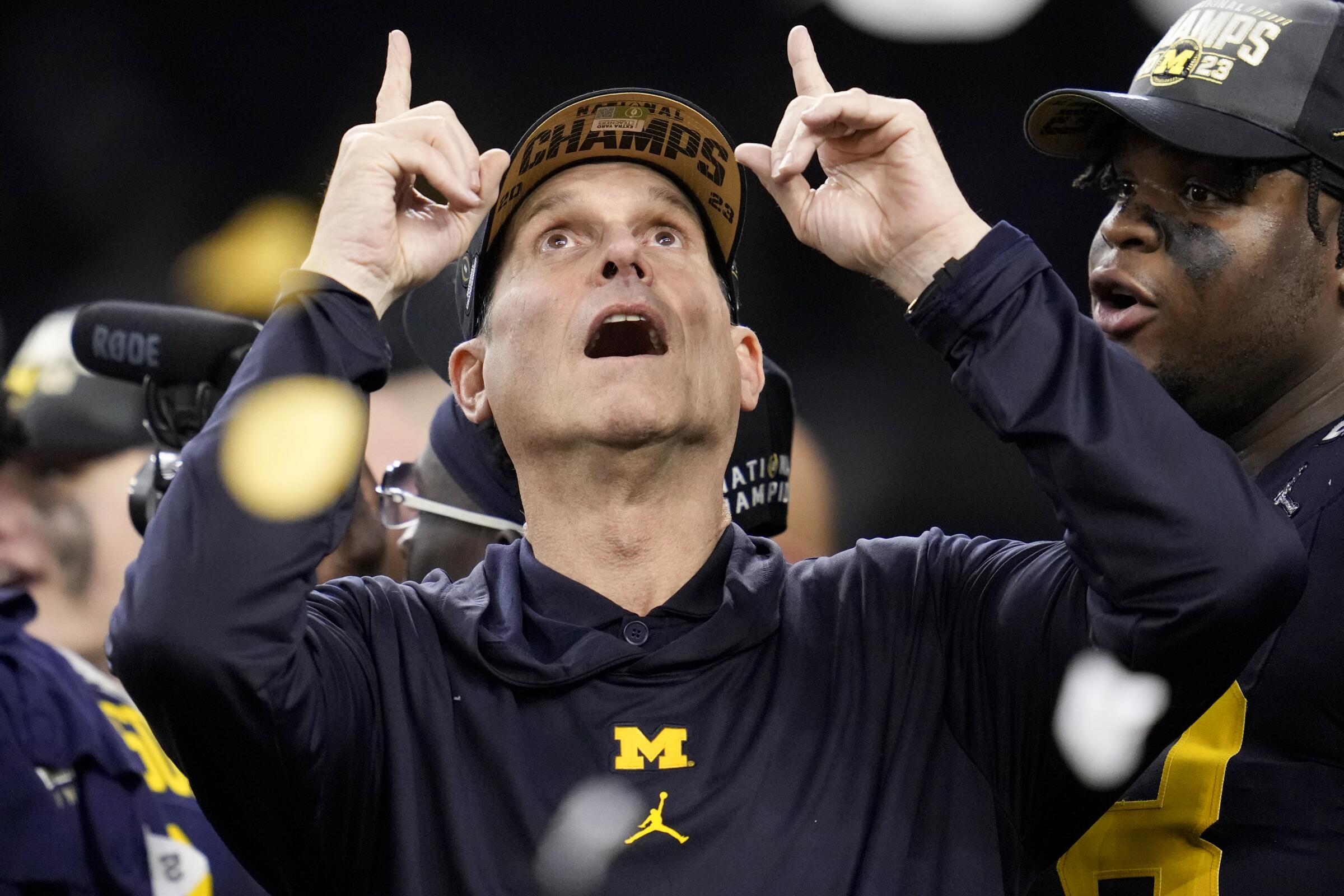 Jim Harbaugh celebrates after guiding Michigan to a national championship victory over Washington.
