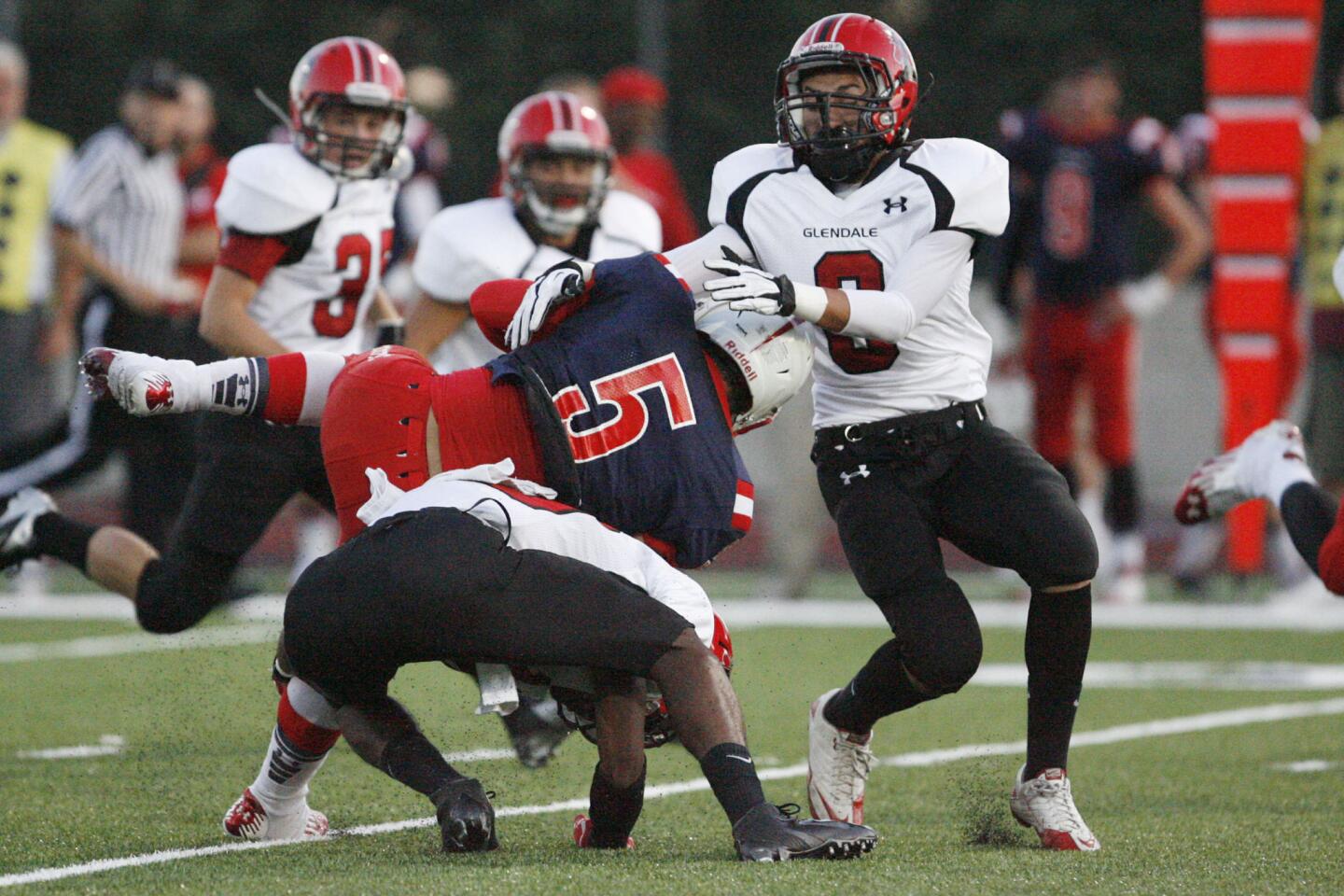 Glendale's Martin Marin, right, tackles La Salle's Kyle Lewis during a game at La Salle High School in Pasadena on Friday, on August 31, 2012.