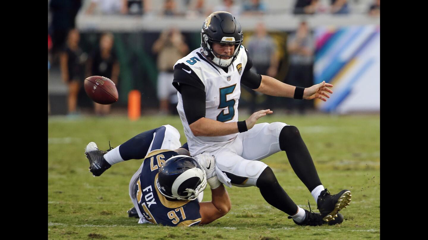 Jacksonville Jaguars quarterback Blake Bortles (5) fumbles the ball as he is tackled by Los Angeles Rams defensive end Morgan Fox during the second half.