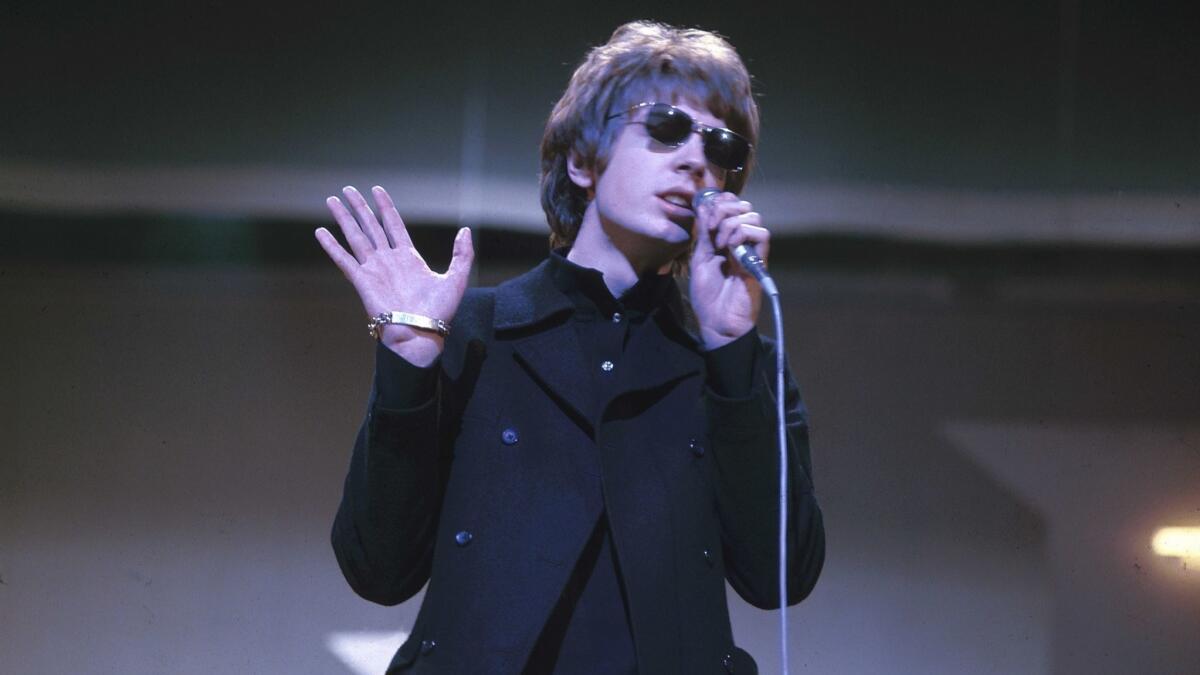 Singer-songwriter Scott Walker of the Walker Brothers performing on television in 1967.