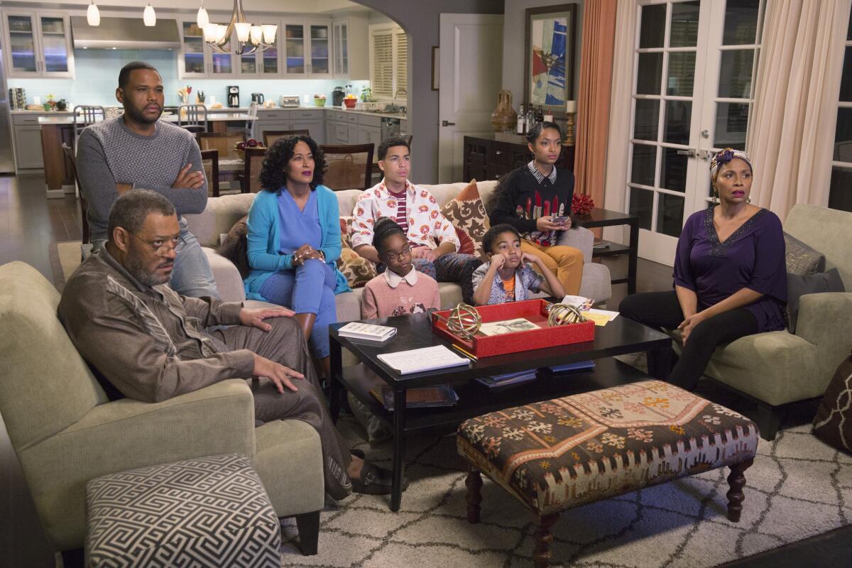 A family sits on a couch.