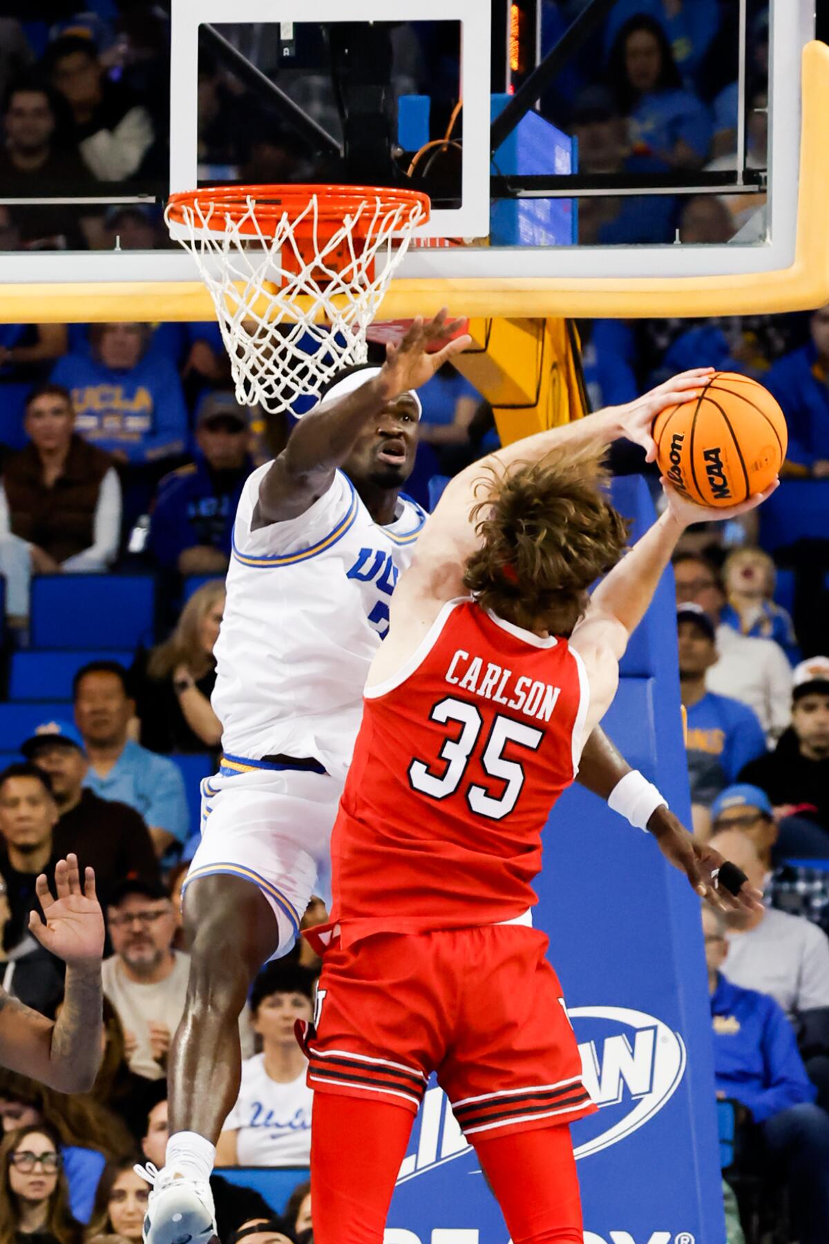 UCLA forward Adem Bona (3) tries to block a shot by Utah center Branden Carlson during the first half.