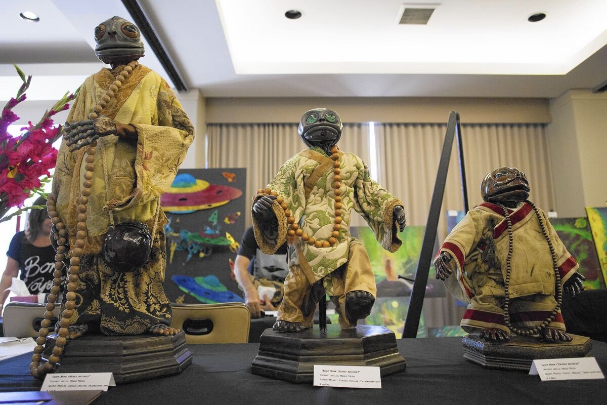 Figures of alien monks made by artist Manuel Cortez were on sale during the Mutual UFO Network's 46th annual conference at the Hotel Irvine on Friday.