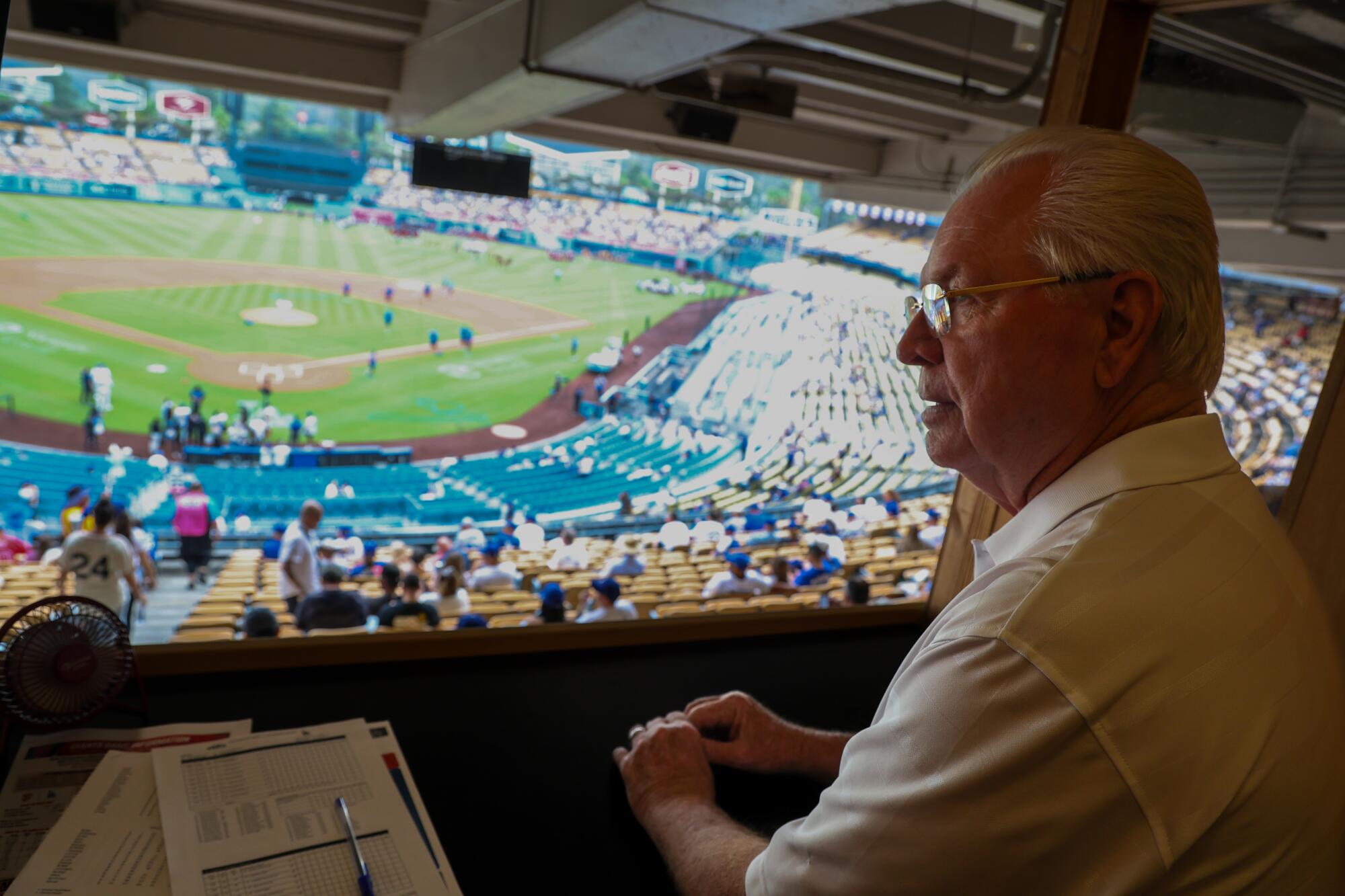 How Invoice Russell stayed related to baseball, and reconnected with the Dodgers 4 Bill Russell at his loge section perch where he observes umpires during games at Dodger Stadium.