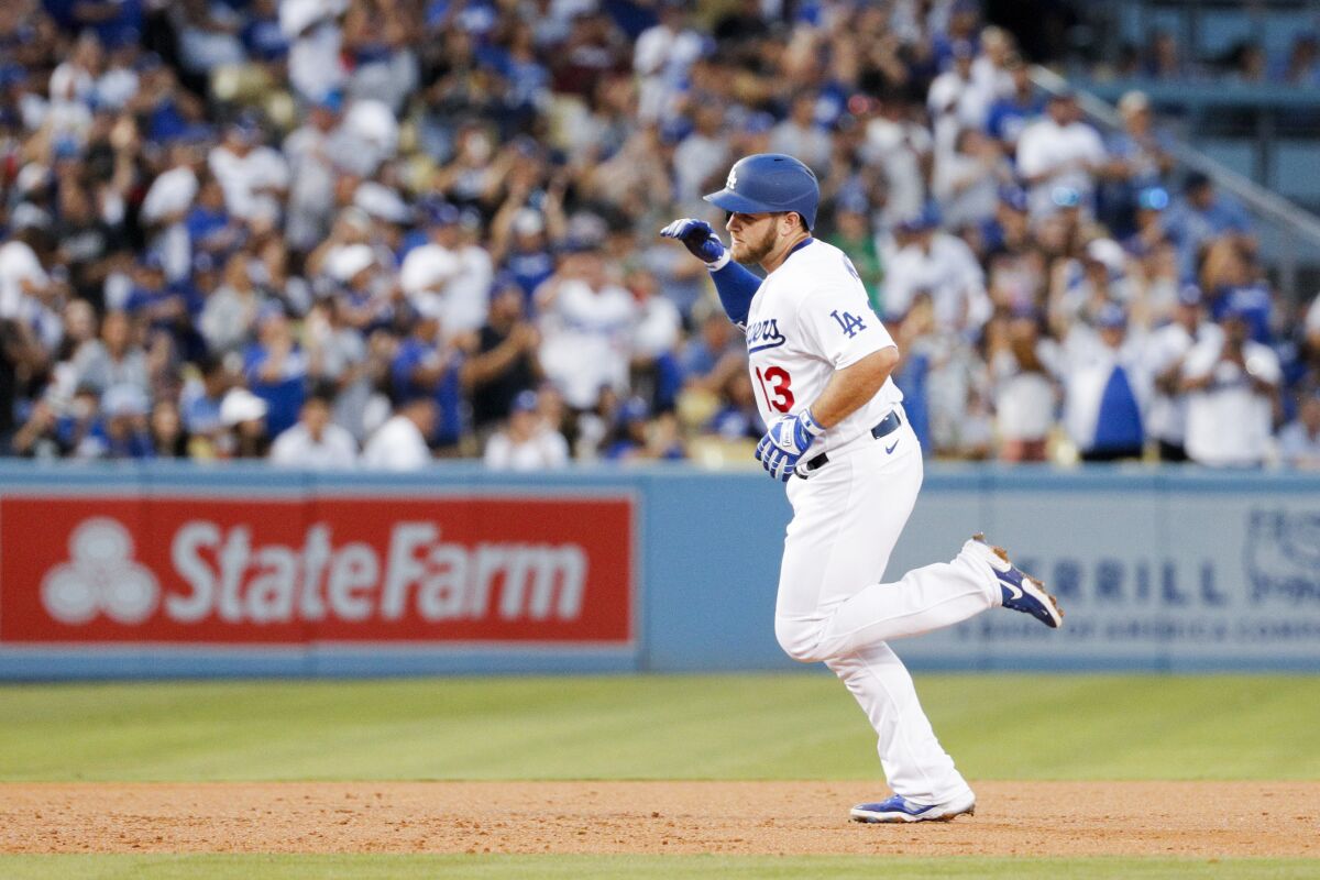 Max Muncy rounds the bases after a solo home run in the second inning.