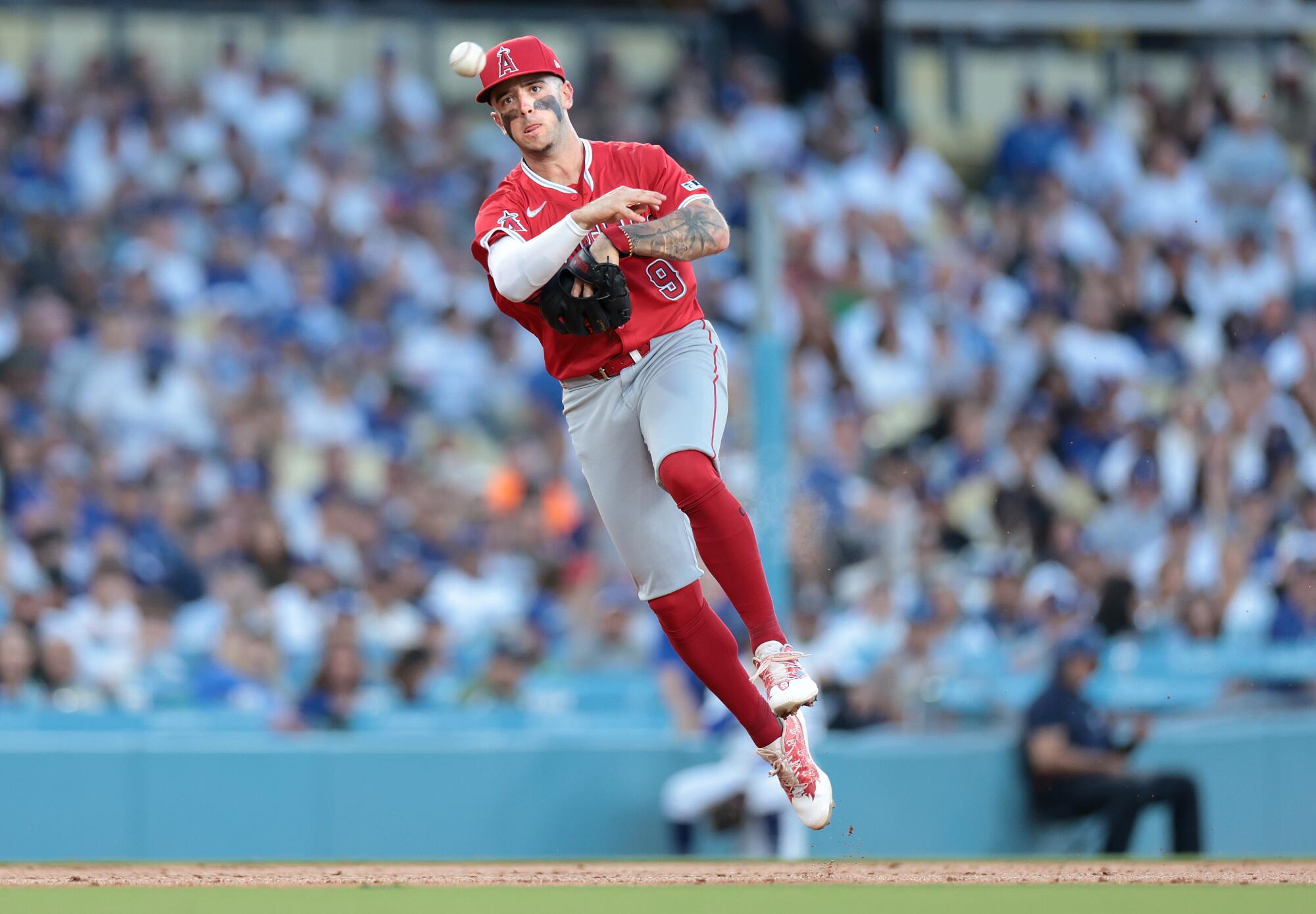 Angels shortstop Zach Neto throws to first base against the Dodgers on Friday.