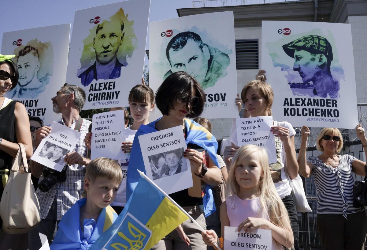 Supporters of Ukrainian filmmaker Oleg Sentsov protest in front of the Russian Embassy in Kiev after a Russian military court sentenced him to 20 years in jail.