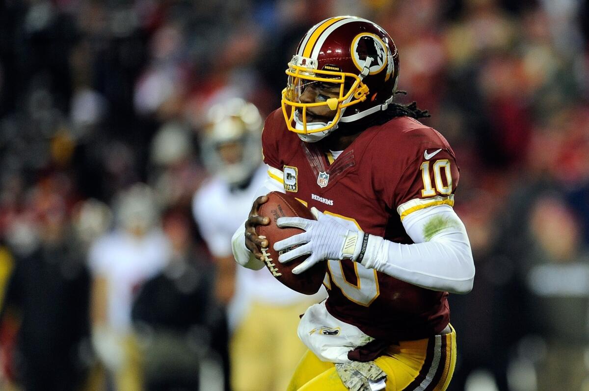 Redskins quarterback Robert Griffin III scrambles for yardage against the 49ers in the fourth quarter Monday night.