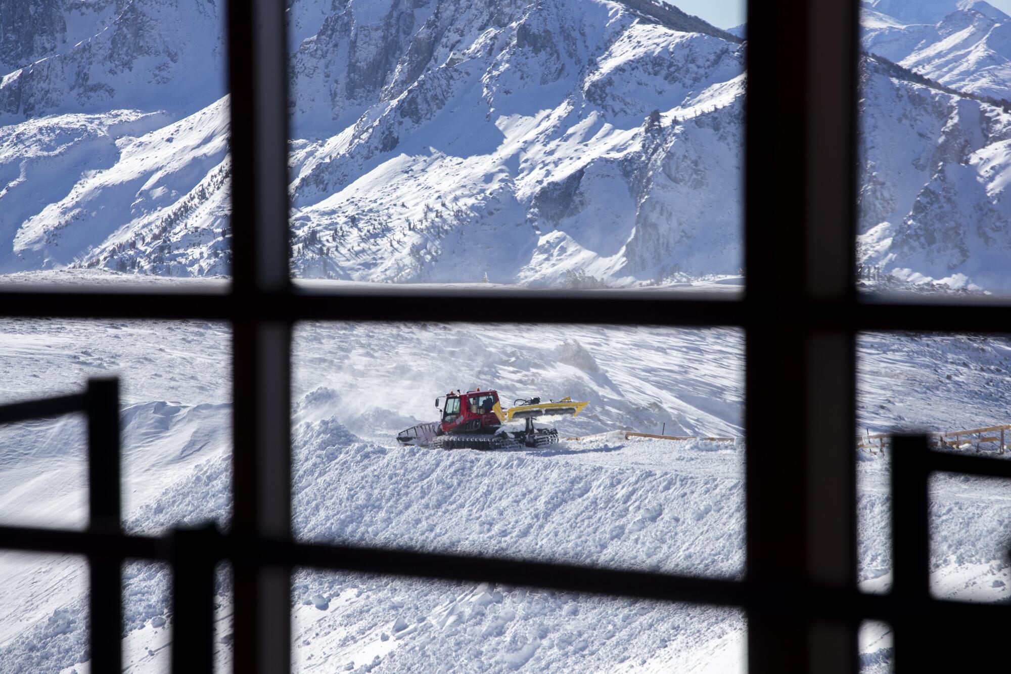 A snow plow grooms Mammoth Mountain's slopes.