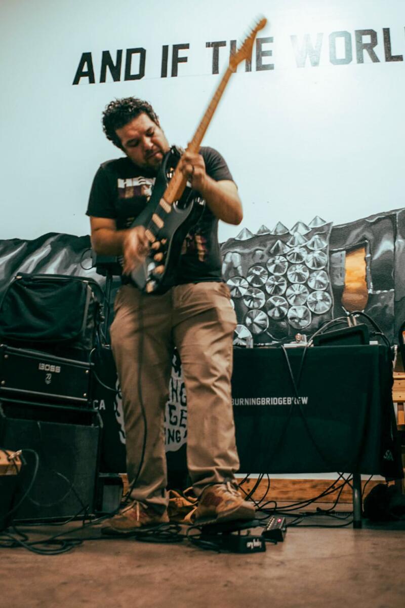 A man playing guitar onstage