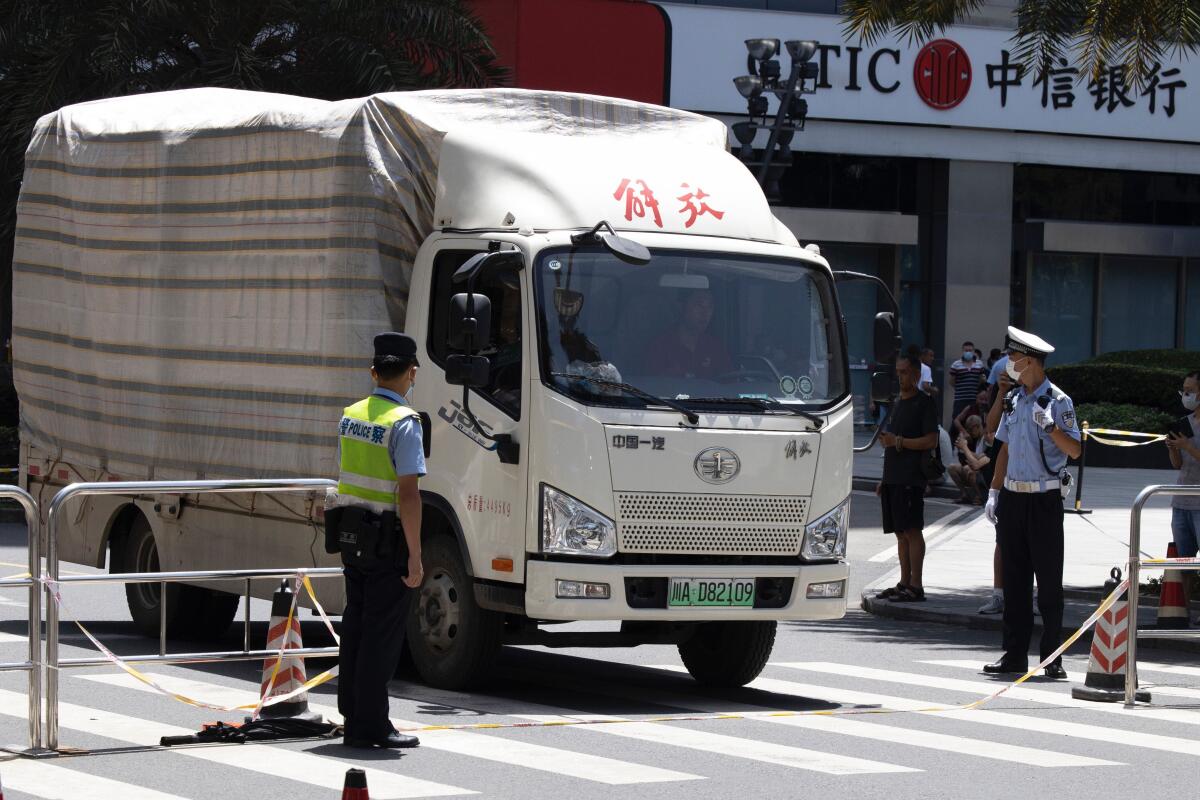 A movers' truck with the words "Liberation" on top arrives outside the United States Consulate in Chengdu, China