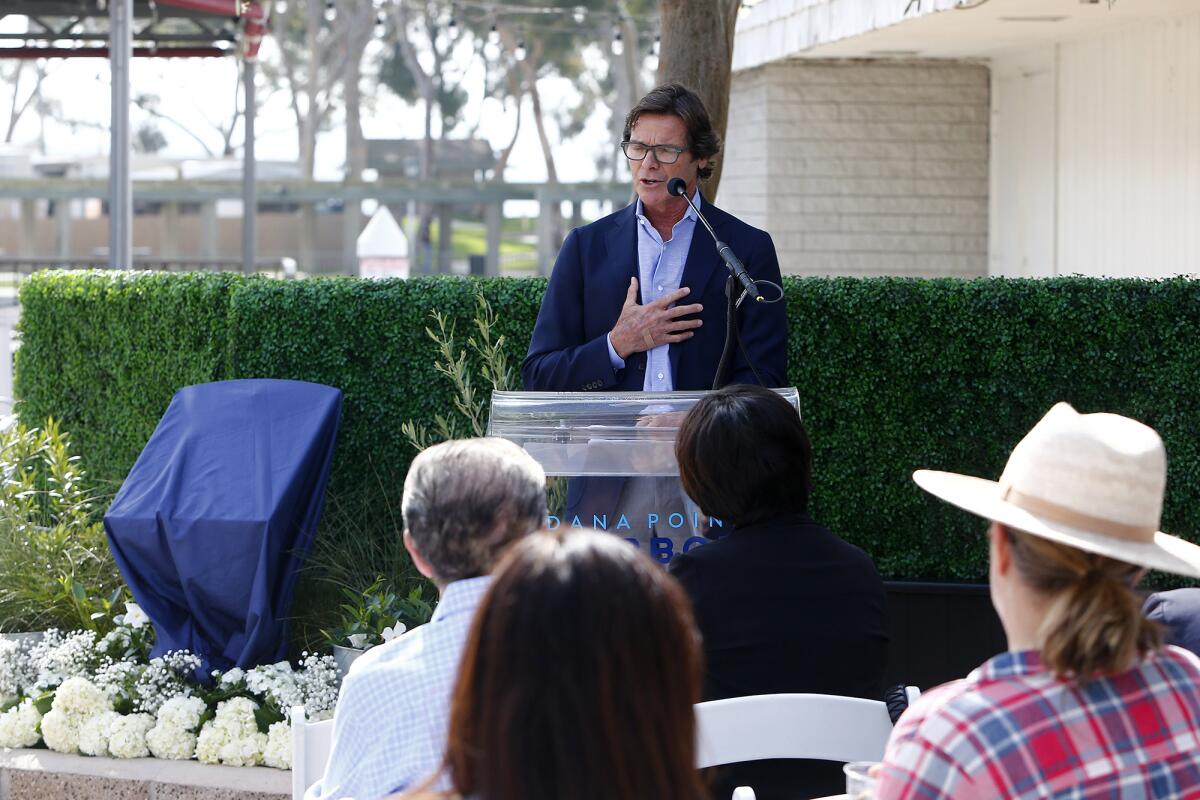 Bryon Ward speaks at the ceremony for the Hansen Plaza plaque.