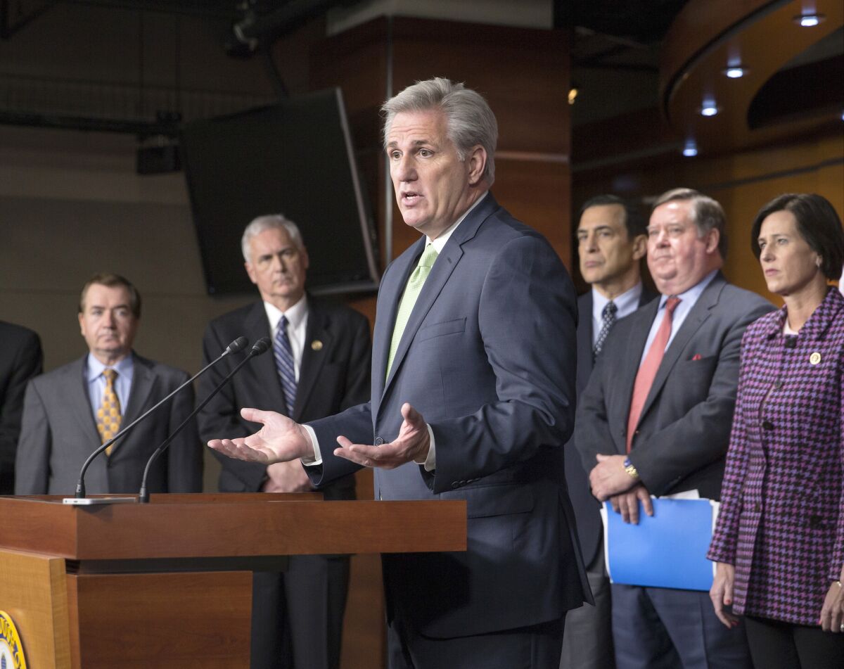 Surrounded by California Republicans, House Majority Leader Kevin McCarthy of Calif., center, answers questions from reporters about attempts to include language addressing the state's drought in a $1.1-trillion government-wide spending bill.
