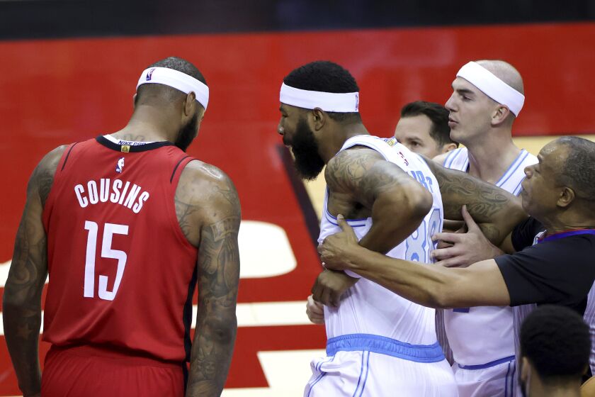 Markieff Morris, right, of the Los Angeles Lakers, reacts towards DeMarcus Cousins, left, of the Houston Rockets before being ejected during the first quarter of an NBA basketball game Sunday, Jan. 10, 2021, in Houston, Texas. (Carmen Mandato/Pool Photo via AP)