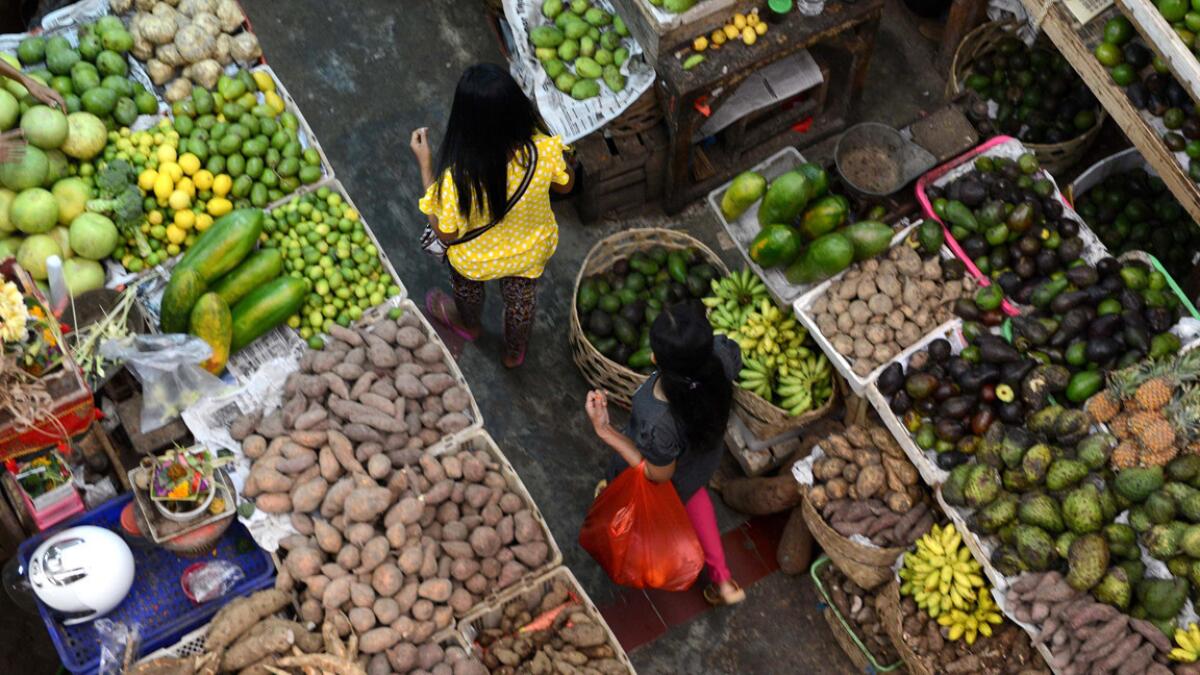 Colorful fruits and vegetables are on display at a market on Bali, the focus of a culinary excursion.