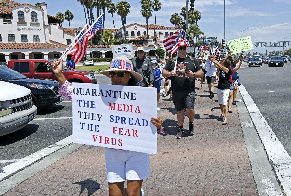 Anti-mask protesters walked onto the crosswalks during rally against mask orders implemented by the city of Costa Mesa.