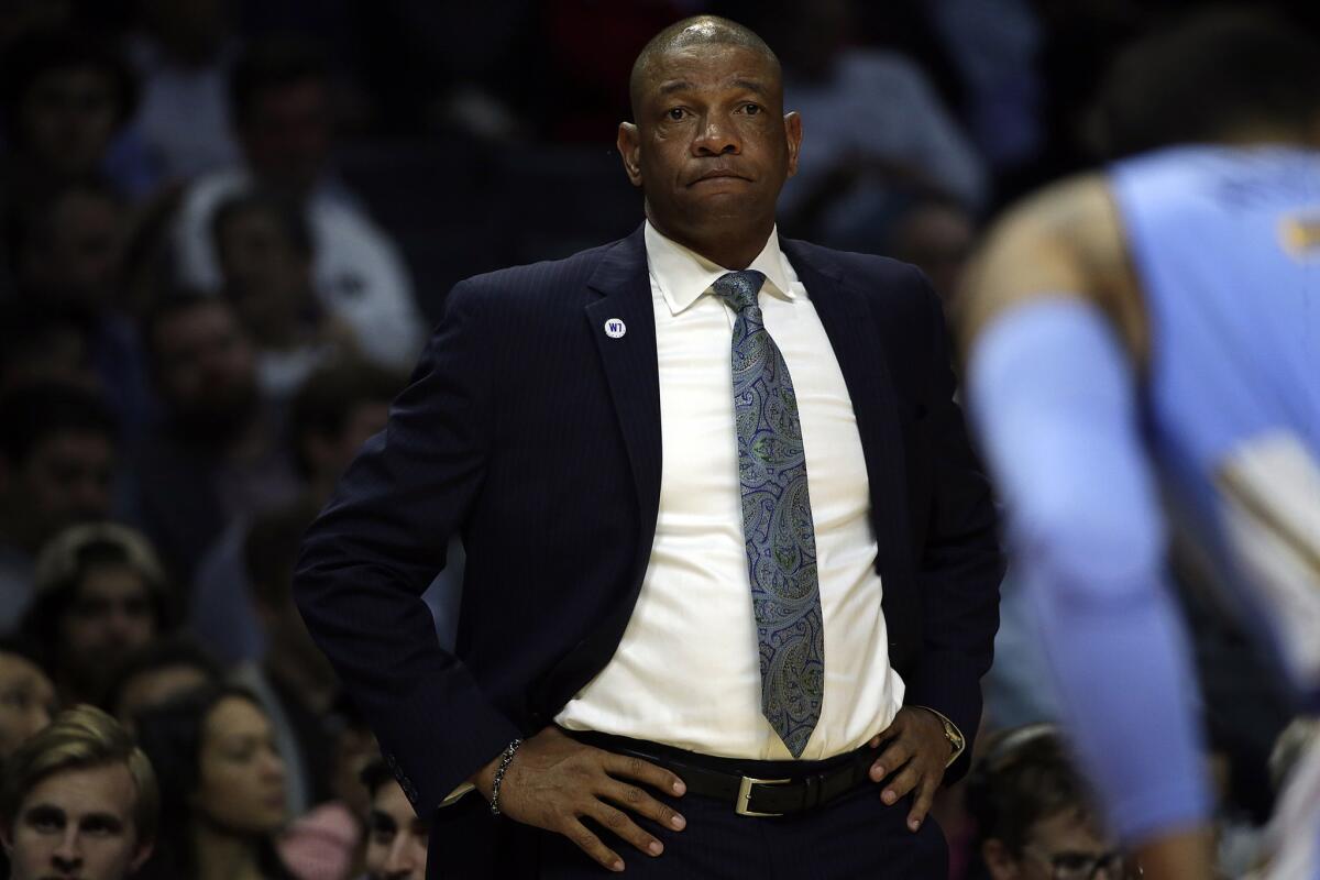 Clippers Coach Doc Rivers paces the sideline during the loss to the Nuggets on Wednesday at Staples Center.