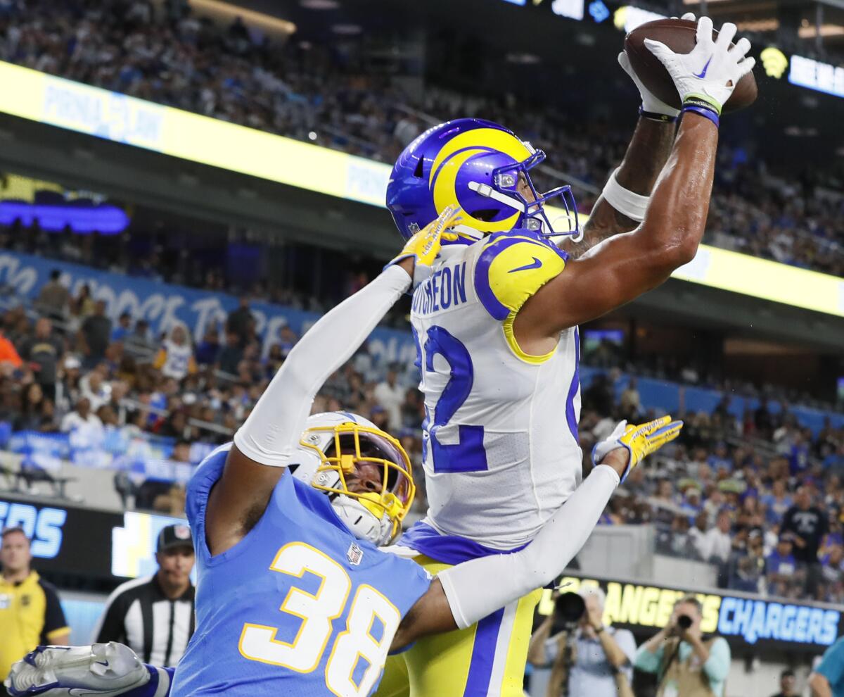 Rams wide receiver Lance McCutcheon catches a touchdown pass over Chargers cornerback Brandon Sebastian on Saturday.