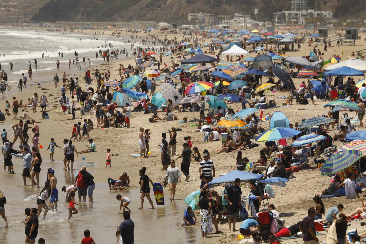 Santa Monica, CALIFORNIA—May 30, 2021--People flock to Santa Monica Pier and Santa Monica beach on Memorial Day, May 30, 2021. (Carolyn Cole / Los Angeles Times)