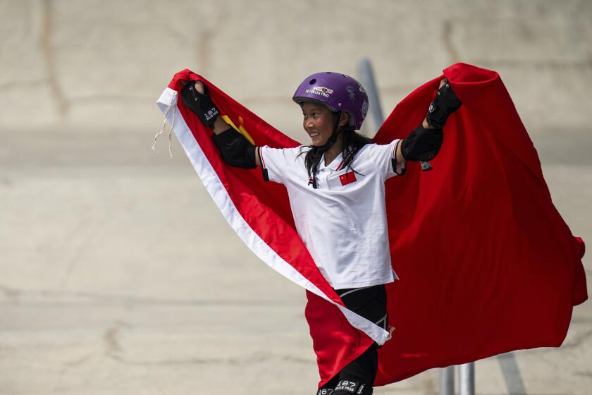 China's Cui Chenxi celebrates after wining the gold medal for skateboarding women's street final at the 19th Asian Games in Hangzhou, China, Wednesday, Sept. 27, 2023. (AP Photo/Louise Delmotte)