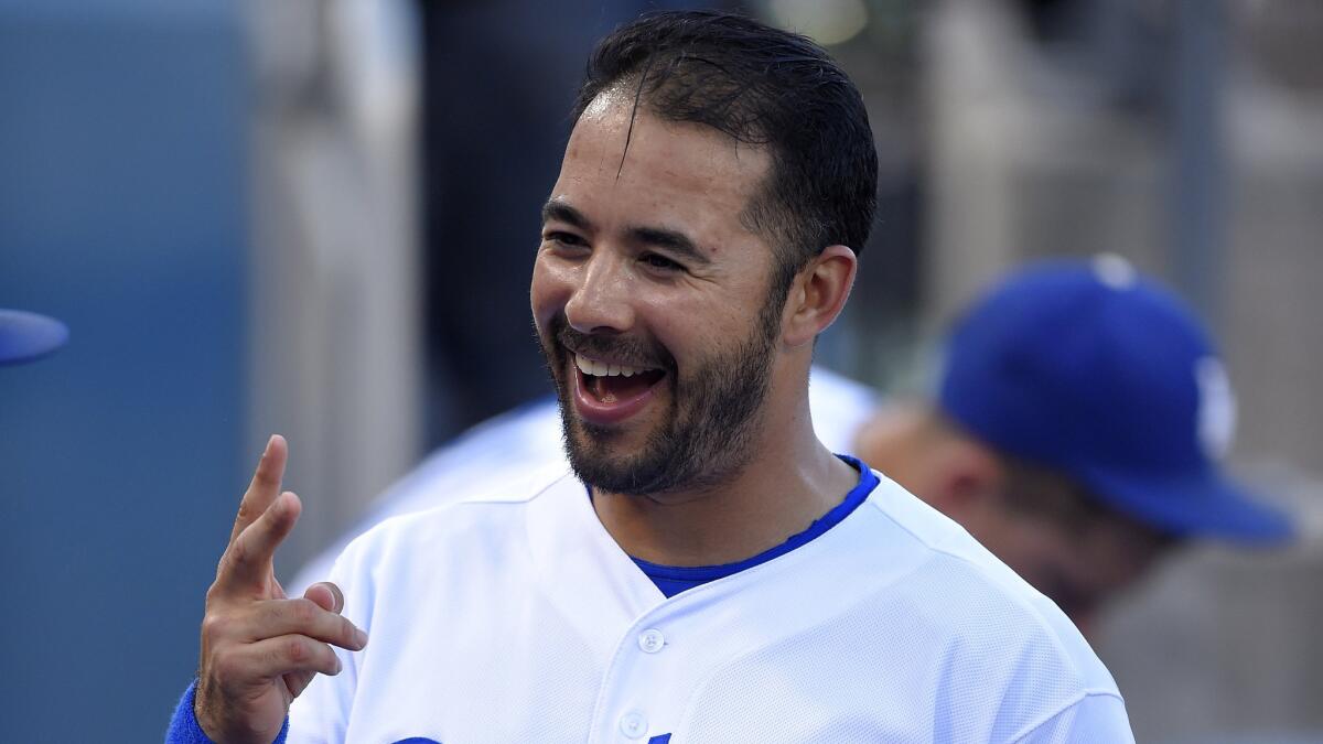 Dodgers left fielder Andre Ethier smiles while speaking to teammates in the dugout before Friday's loss to the visiting San Francisco Giants.