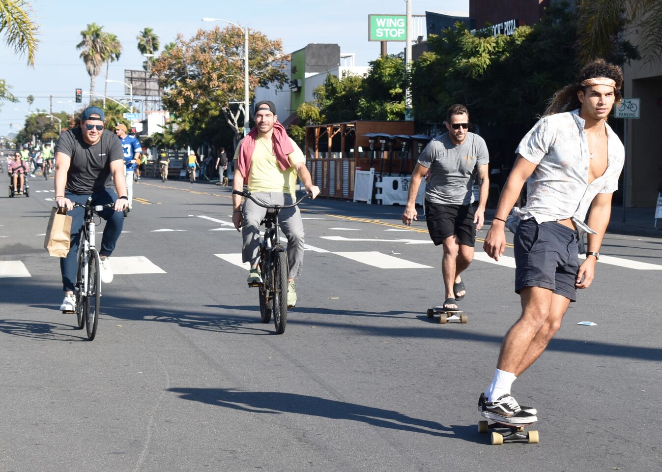 Skateboarders and bicyclists traveled down Garnet Avenue together during CicloSDias in Pacific Beach.
