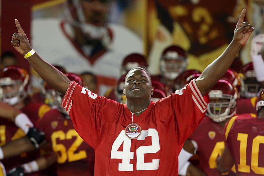 Former USC player Keyshawn Johnson leads the Trojans out of the tunnel before a game against Arizona in 2013.