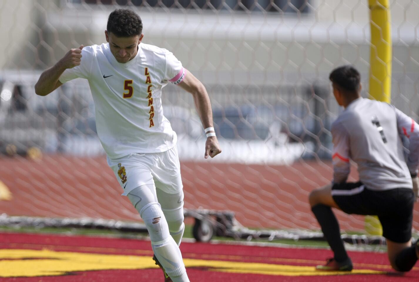 La Cañada High School boys soccer player #5 Sam Adida celebrates scoring a goal during the penalty kicks phase of the game vs. Nogales High School in CIF playoff game at home in La Cañada Flintridge on Saturday, Feb. 25, 2017. LCHS won the game 5-3 in PKs.