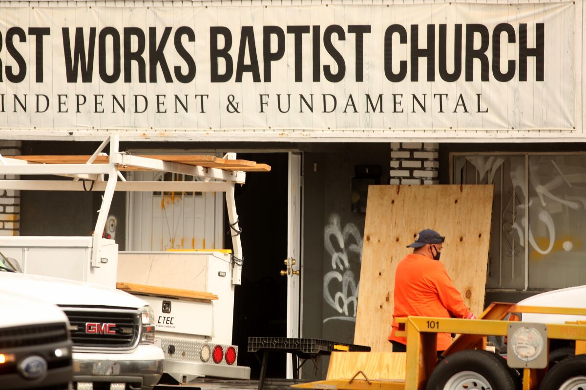 A worker cleans up the scene where authorities are investigating an explosion at the First Works Baptist Church.