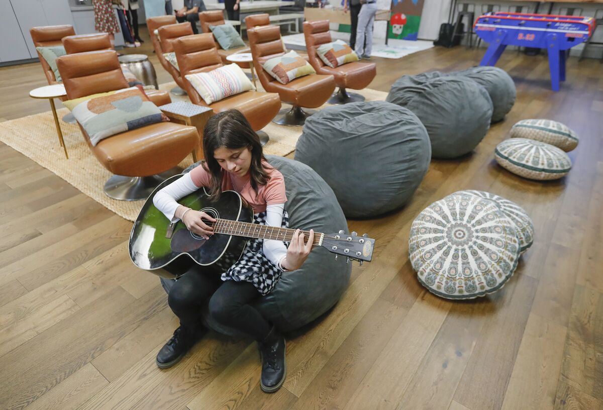 Chloe Hajali plays guitar in the new well space room at the Boys & Girls Club of Laguna Beach.