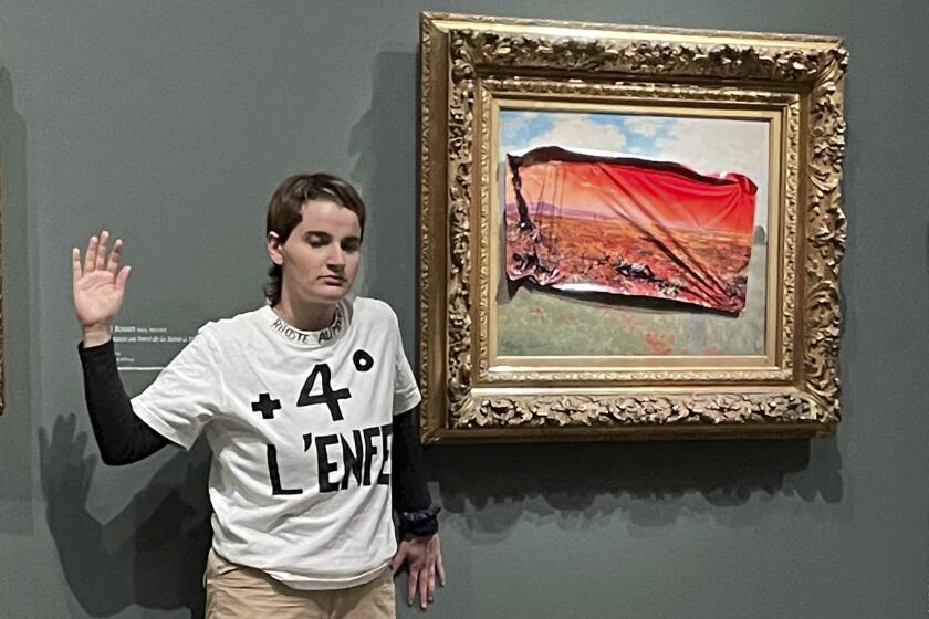 This photo provided by Riposte Alimentaire shows an environmental activist posing by 'Poppy Field'' by Claude Monet at the Orsay museum, Saturday, June 1, 2024 in Paris. The activist was detained after sticking a protest sign on a Monet painting, calling for action to protect food supplies from further damage to the climate. (Riposte Alimentaire via AP)