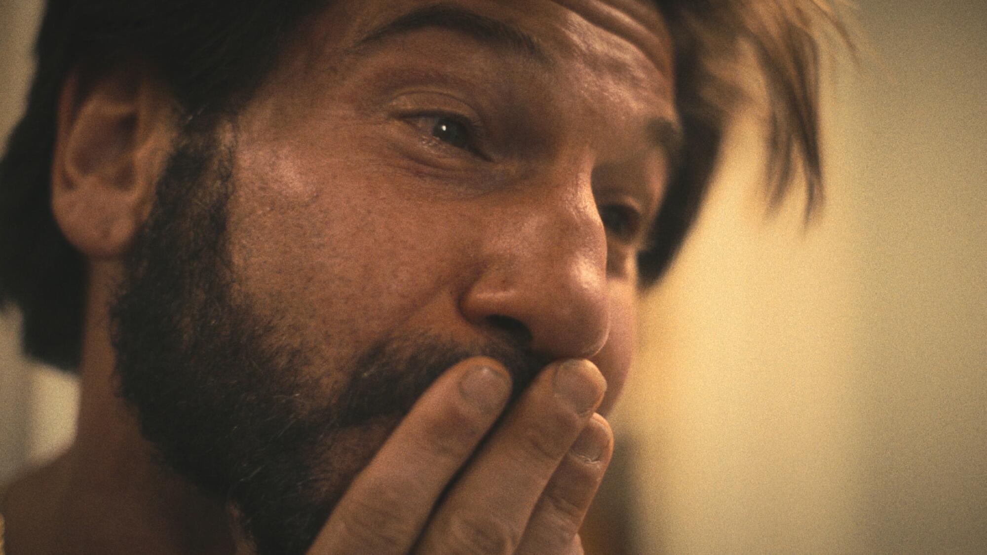 Jon Bernthal presses his fingers to his mouth and looks upset in "The Bear."