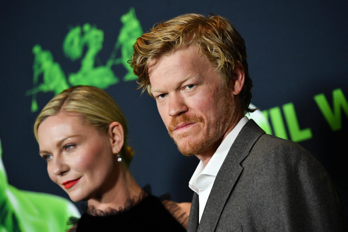 Actors walk a red carpet at a screening.