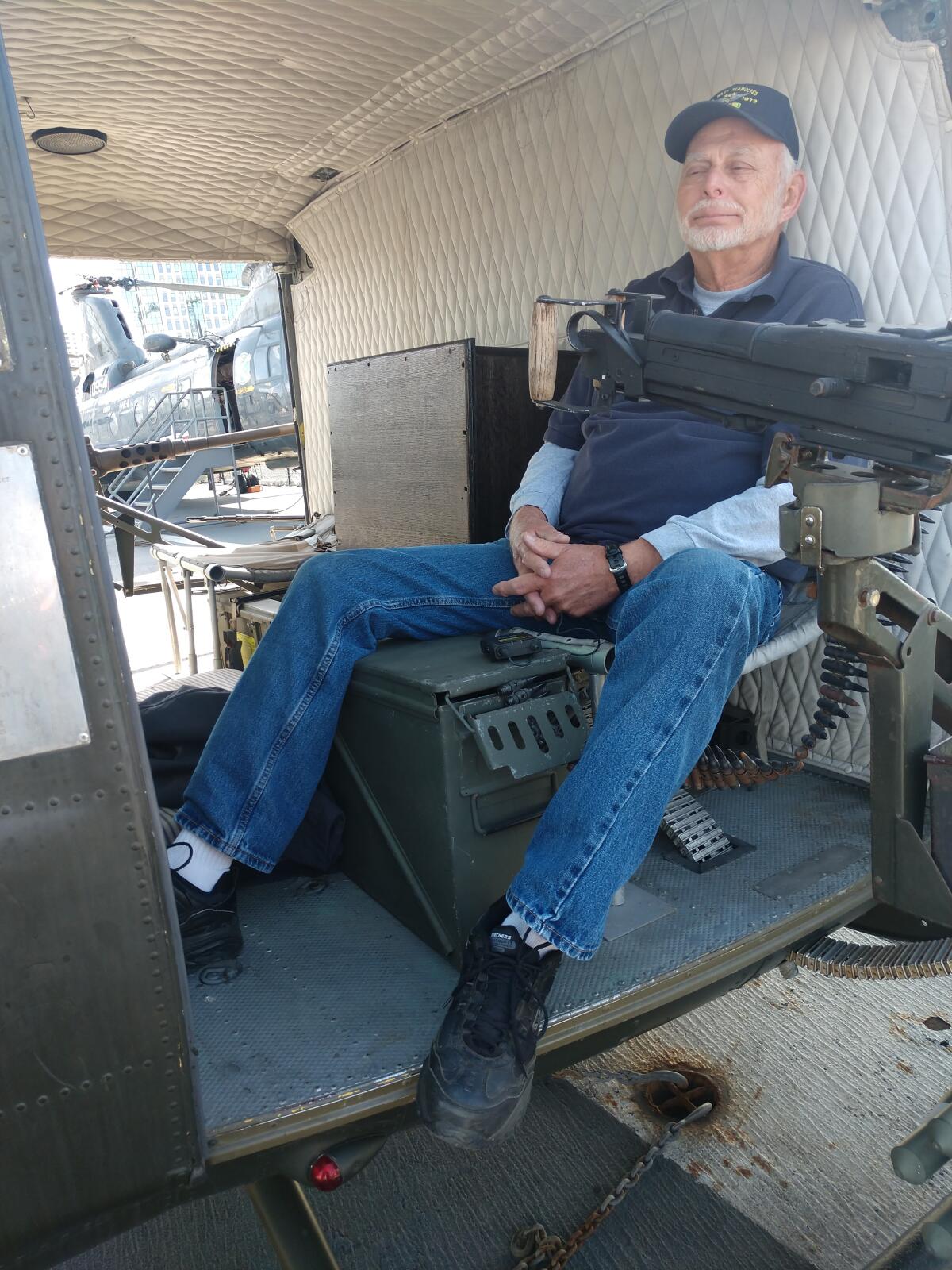 Gary Ely sits in a helicopter at the USS Midway Museum, where he is a volunteer.