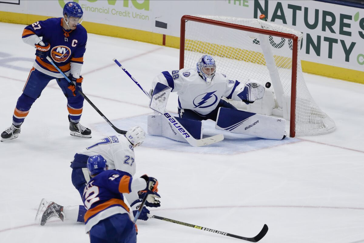 New York Islanders' Josh Bailey (12) shoots the puck past Tampa Bay Lightning goaltender Andrei Vasilevskiy (88) for a goal as Islanders' Anders Lee (27) and Lightning's Ryan McDonagh (27) watch during the third period of an NHL hockey game Friday, Nov. 1, 2019, in Uniondale, N.Y. The Islanders won 5-2. (AP Photo/Frank Franklin II)
