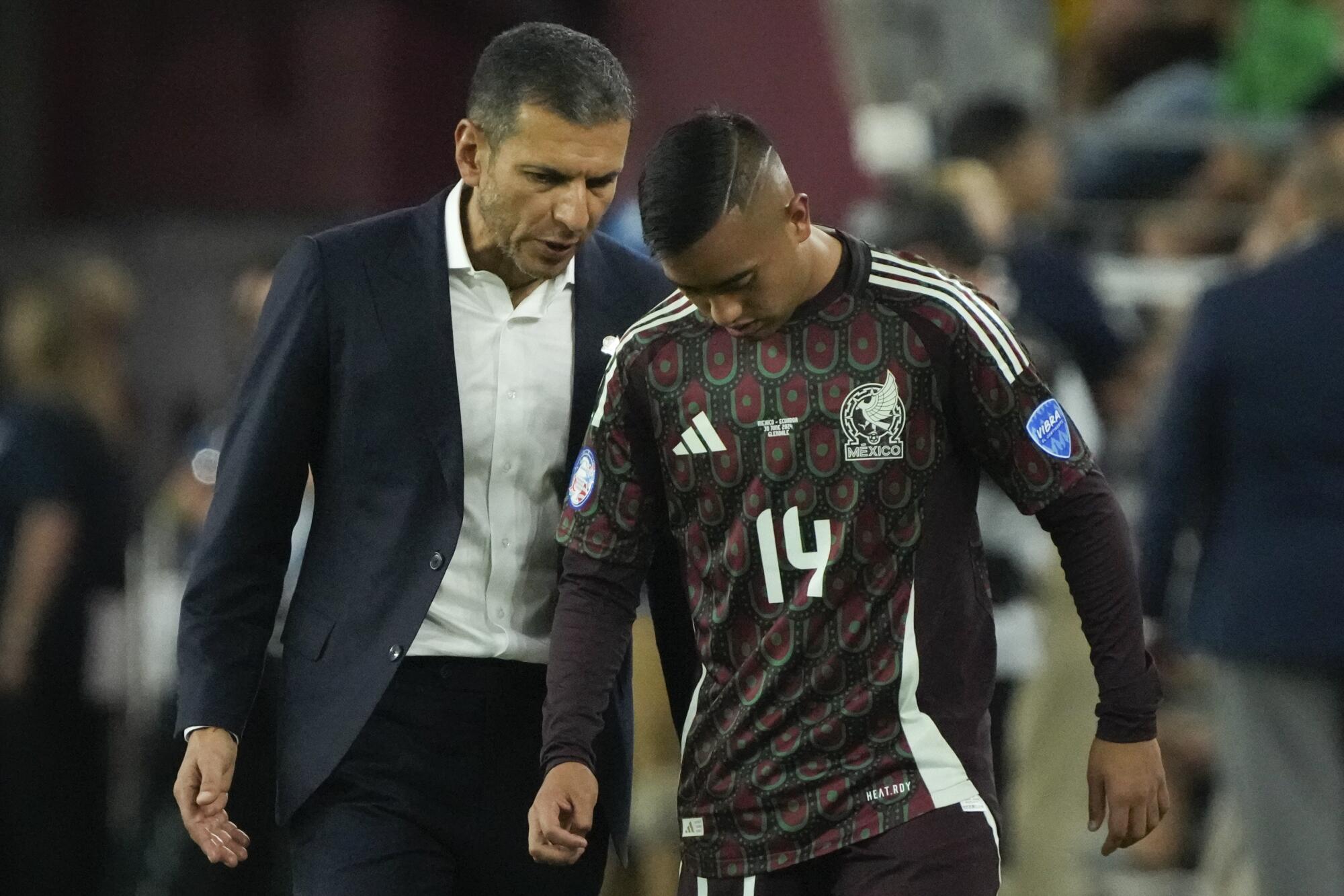 Mexico's coach Jaime Lozano, left, gives inst 