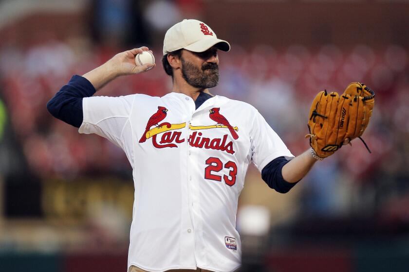 Missouri native Jon Hamm throws out a ceremonial first pitch before the Monday night game between the St. Louis Cardinals and the Cincinnati Reds in St. Louis.