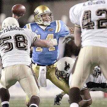 UCLA's Drew Olson is tackled and injured on this play against Wyoming in the second quarter of the Las Vegas Bowl.