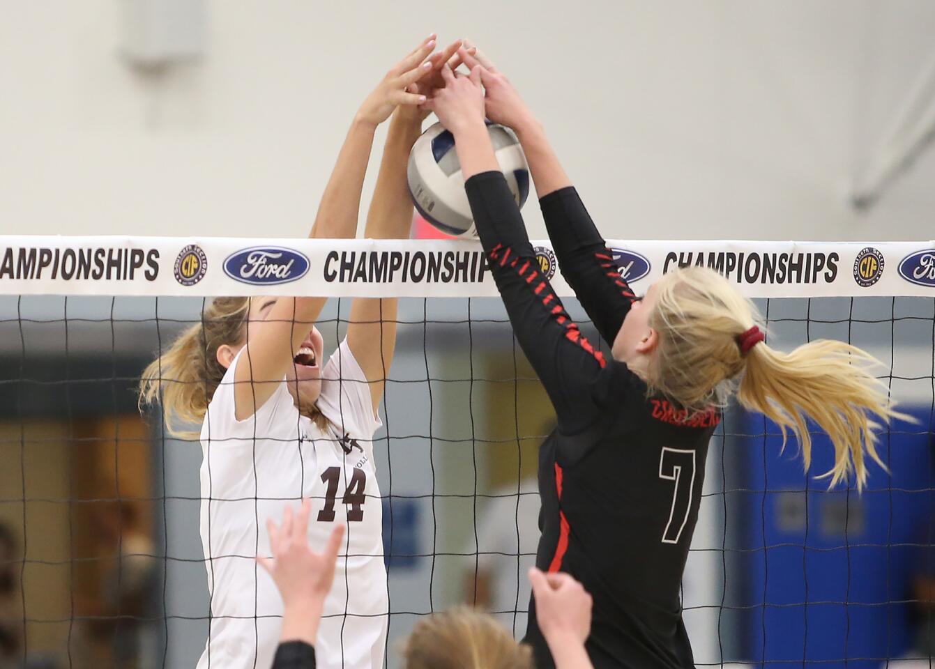 Laguna Beach High's Piper Naess (14) jousts at the net with Sun Valley Village Christian's Kendall Jensen in the CIF Southern Section Division 3 championship match at Cerritos College on Saturday.