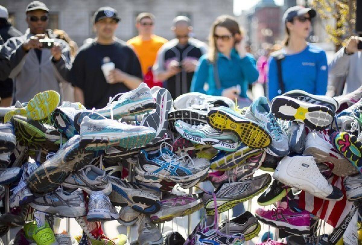 Running shoes are part of a makeshift memorial in Copely Square honoring victims of the Boston Marathon bombing.