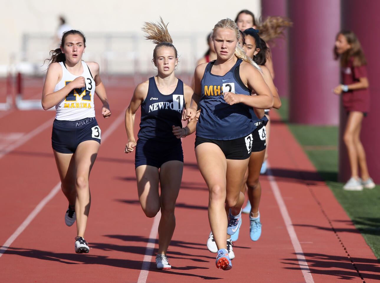 Marina High's Grace Ellis (2) hits her stride to the finish line and wins the girls' 800-meter event during the Wave League finals at Laguna Beach on Thursday.